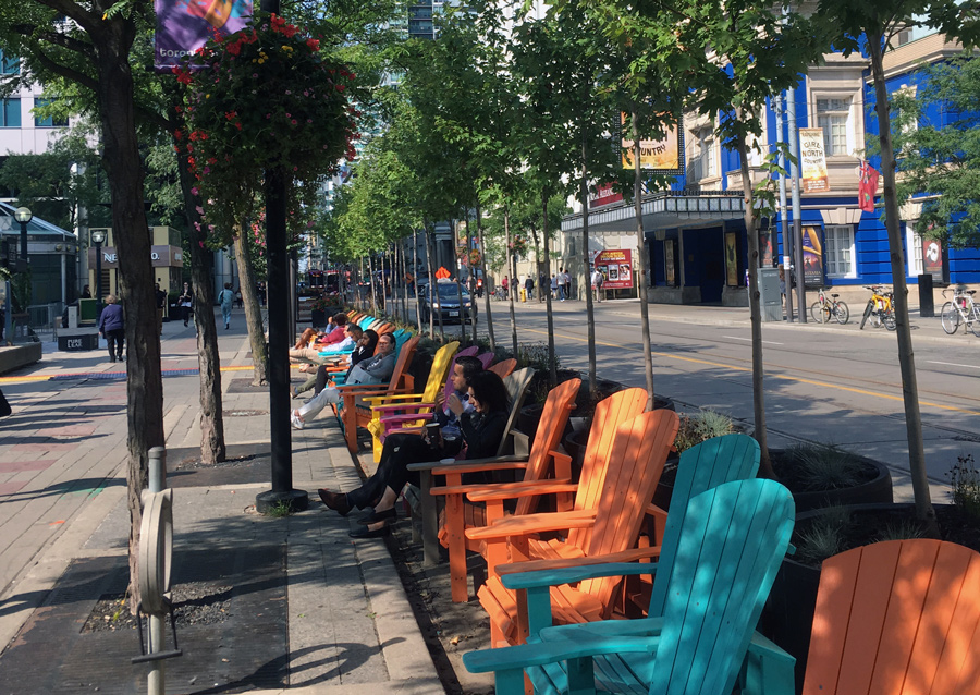 Temporary installation of trees can help add greenery quickly and helps create street life